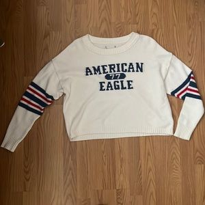 AE white sweater with red and blue striped sleeves